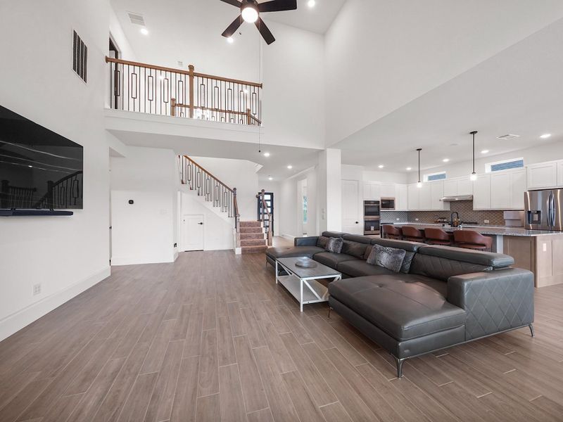This angle highlights how the living room connects to the kitchen and dining areas, creating a seamless flow that encourages togetherness. Whether hosting a lively get-together or enjoying a quiet evening, this space adapts to your needs.