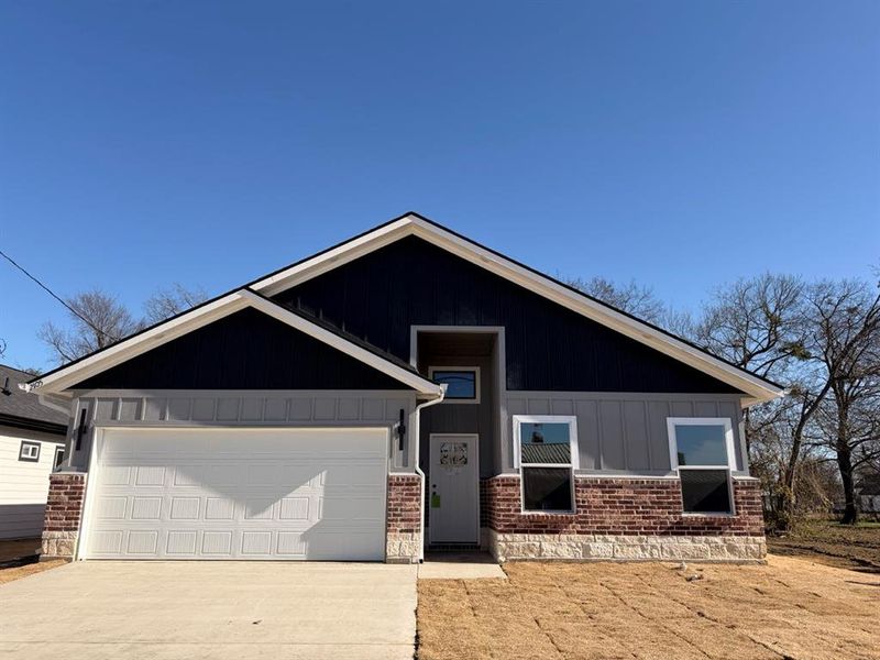 View of front of property featuring concrete driveway, a garage, and brick siding View of front of property featuring concrete driveway, a garage, and brick siding