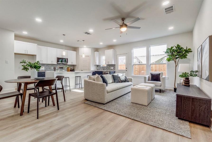 Living room featuring light wood-type flooring and ceiling fan