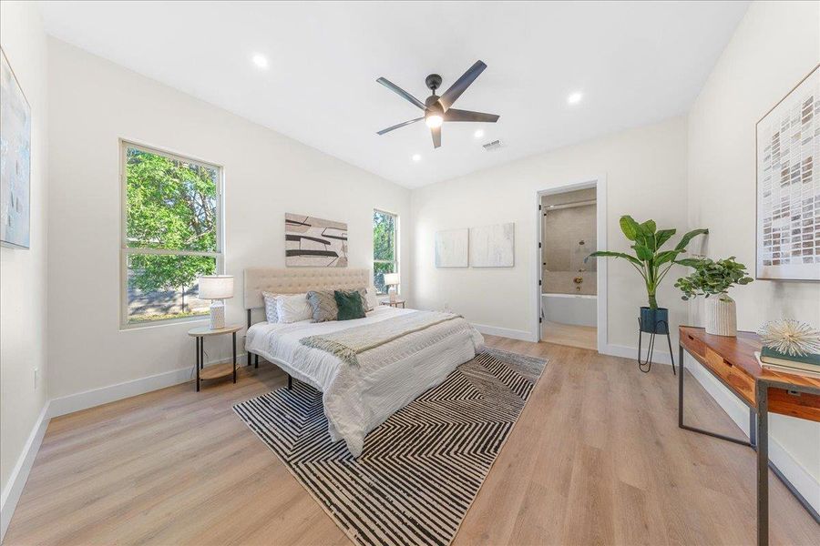 Bedroom with recessed lighting, visible vents, light wood-type flooring, and baseboards