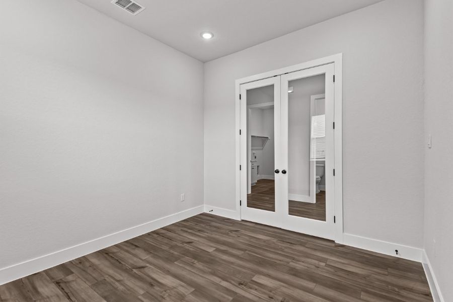 A room with a wood floor and a wood floor.