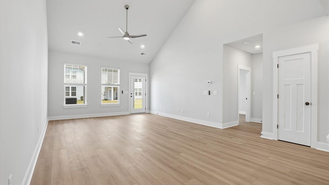 Spacious and stylish family room with two-story ceilings that create a bright and open atmosphere at Village at Midway Spacious and stylish family room with two-story ceilings that create a bright and open atmosphere at Village at Midway