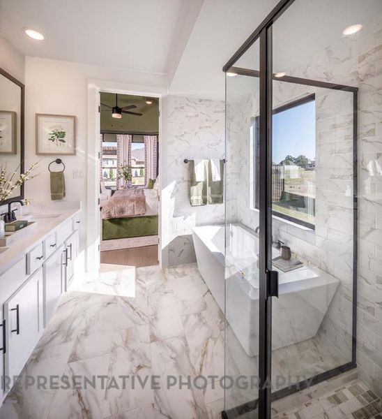 Ensuite bathroom with marble look tile flooring, recessed lighting, a freestanding bath, vanity, and ceiling fan