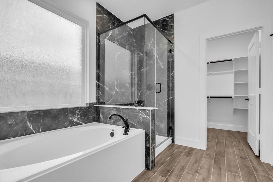 Primary Suite Bath welcomes you into this spa like retreat with large soaking tub, Walk in Shower and Generous sized Walk in Closet.