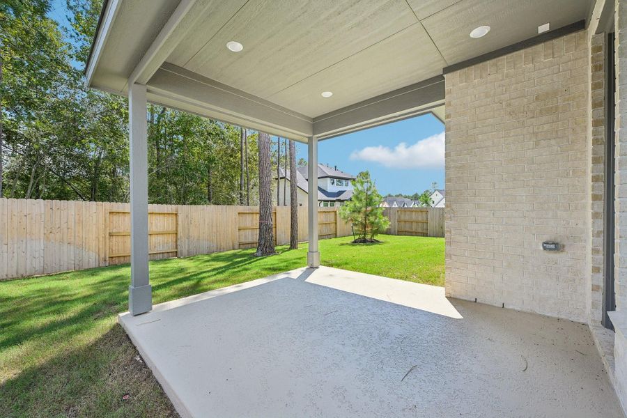 Exterior details and patio area of a home in Woodhavyn 50', Magnolia (Image 16).