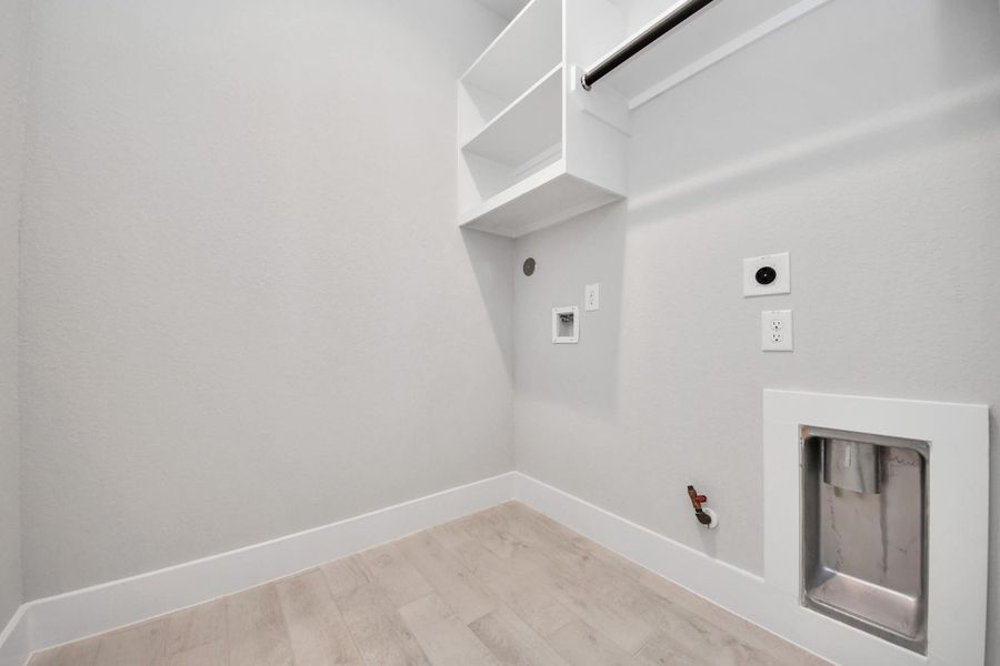 A perfect blend of functionality and comfort. Capture the essence of easy living with a first-floor laundry room, thoughtfully equipped with shelving for effortless organization. Both electric and gas connections available.