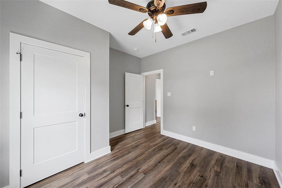 Unfurnished bedroom featuring wood finished floors and a ceiling fan