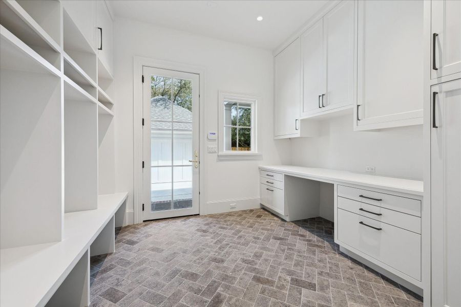 Mudroom of the back door to the garage. Has custom storage & lockers and a working station. Mudroom of the back door to the garage. Has custom storage & lockers and a working station.