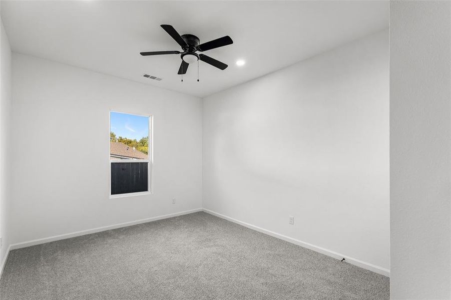 Spare room featuring carpet, a ceiling fan, and recessed lighting