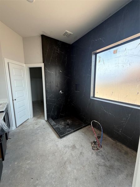 Stunning modern finishes in this main bathroom will include a freestanding bathtub surrounding by sleek, black tile to the ceiling. Stunning modern finishes in this main bathroom will include a freestanding bathtub surrounding by sleek, black tile to the ceiling.