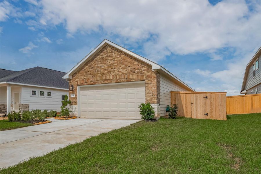 Front exterior of a new home in Woodland Lakes, Huffman, TX, highlighting curb appeal (Image 1).