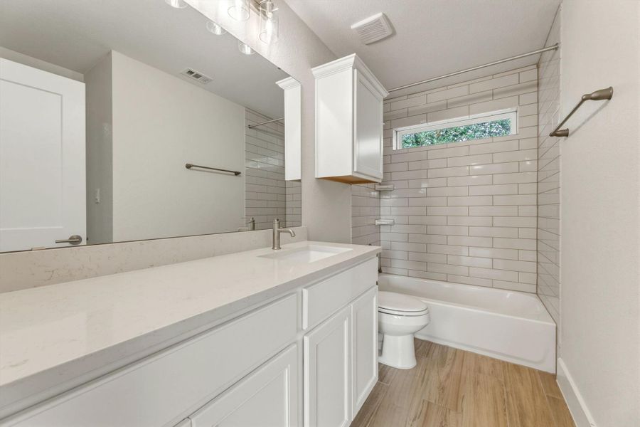 Full bath with nice sized vanity.