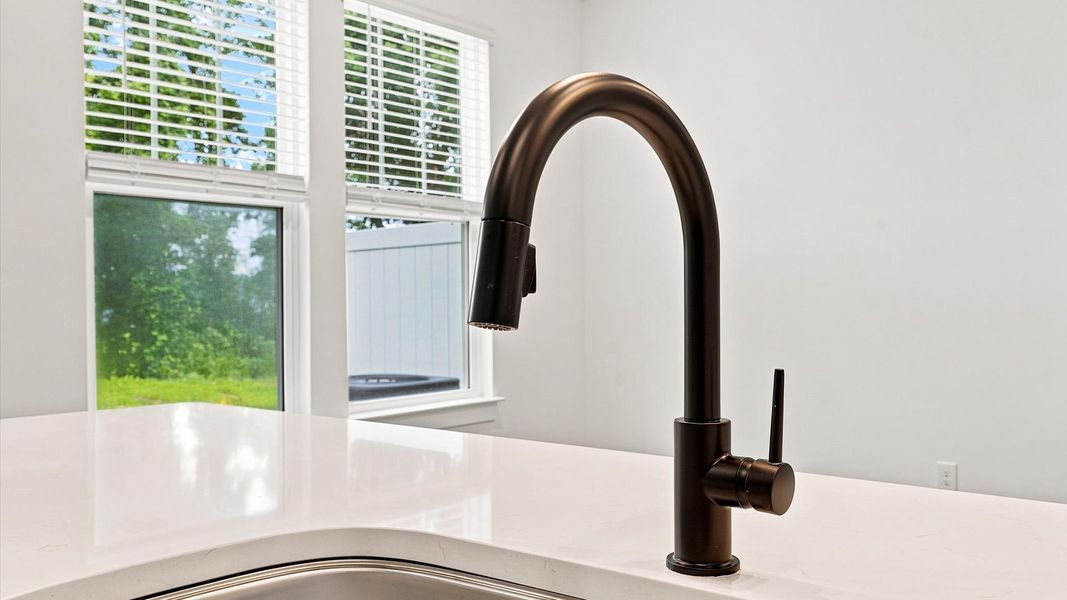 Superior kitchen with quartz countertops, a generously sized island, and abundant natural light