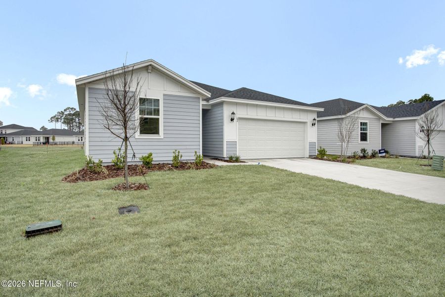 Front exterior of a new home in , Palm Coast, FL, highlighting curb appeal (Image 1). Front exterior of a new home in , Palm Coast, FL, highlighting curb appeal (Image 1).