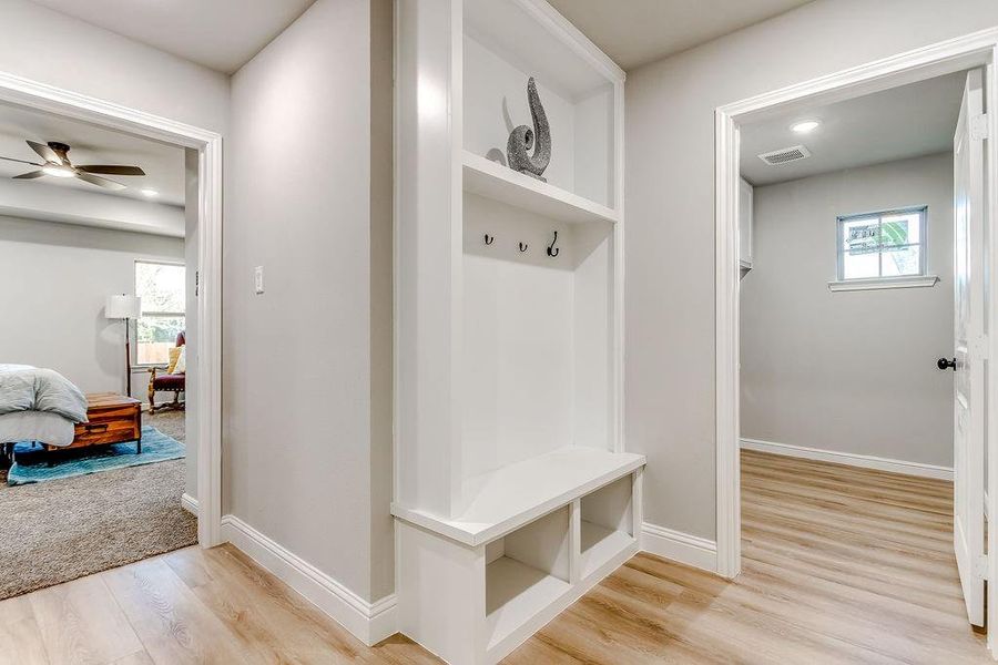 Mudroom featuring ceiling fan, light wood-type flooring, and a wealth of natural light