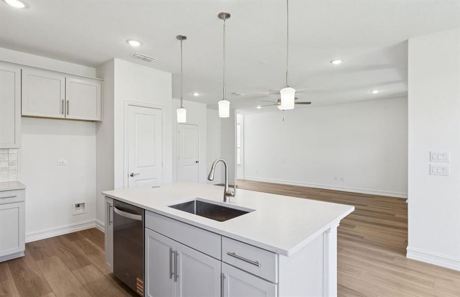 Large island overlooking gathering room and dining areas