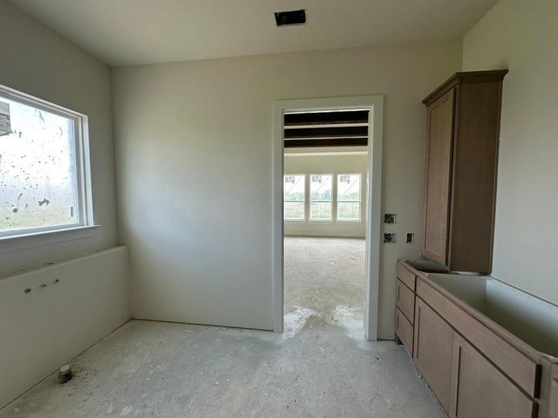 Space featuring a single window, built-in cabinetry, and neutral wall finishes