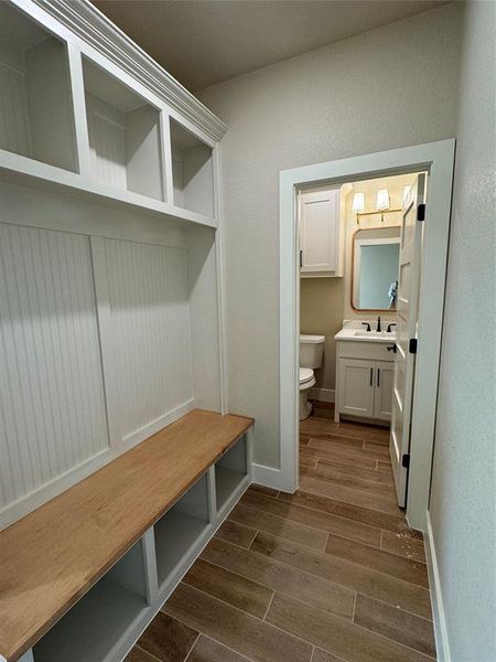 Mudroom with dark hardwood / wood-style flooring and sink