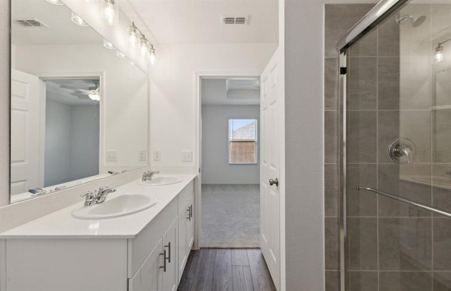 Owner's bath with dual vanity and oversized shower*real home pictured