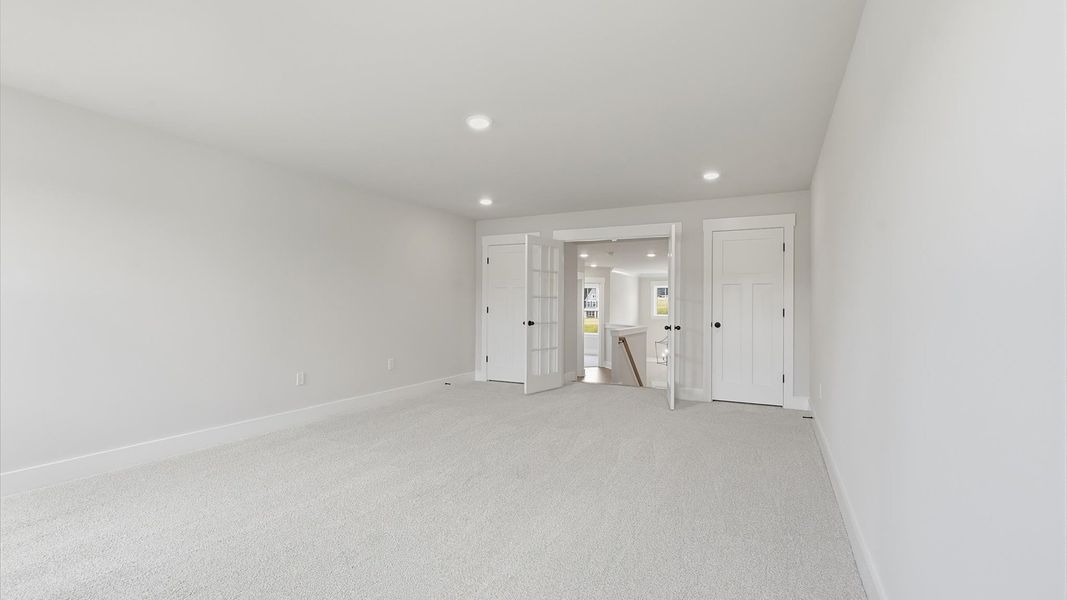 Superior bonus space with soft carpet, ideal for work, relaxation, or entertainment by DRB Homes Superior bonus space with soft carpet, ideal for work, relaxation, or entertainment by DRB Homes