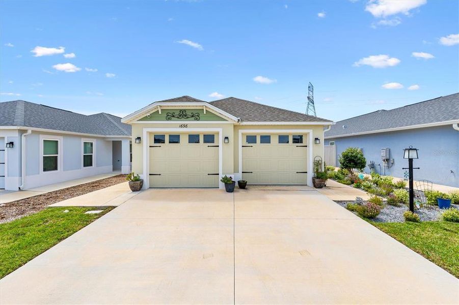 Front exterior of a new home in , The Villages, FL, highlighting curb appeal (Image 18).