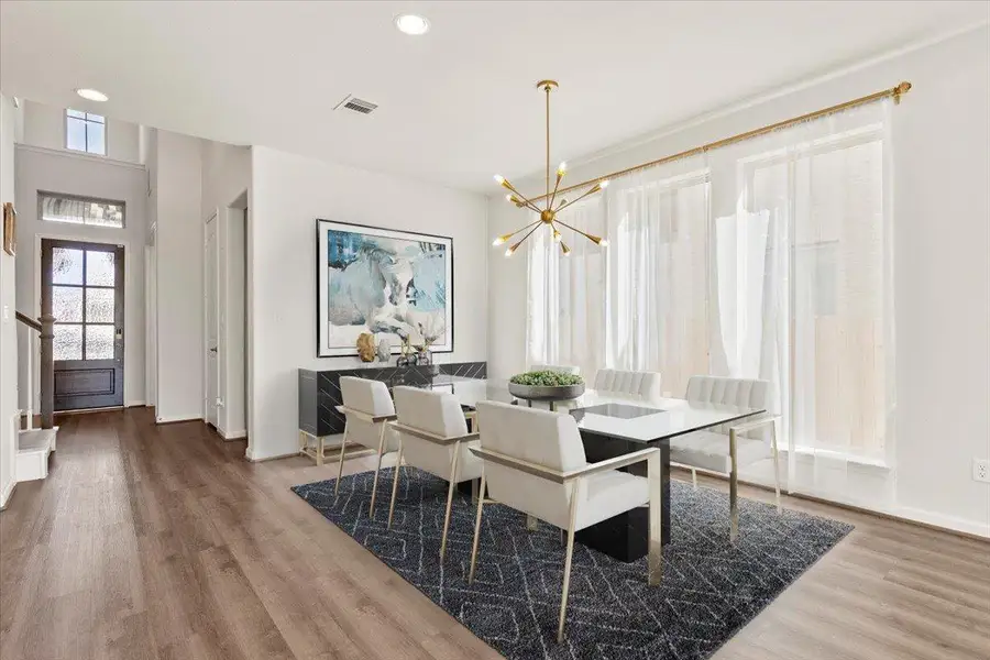 Dining room featuring a chandelier, recessed lighting, light wood finished floors, and stairway. Virtual Staging. Dining room featuring a chandelier, recessed lighting, light wood finished floors, and stairway. Virtual Staging.