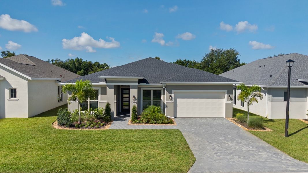 Front exterior of a new home in Turnleaf, Punta Gorda, FL, highlighting curb appeal (Image 1). Front exterior of a new home in Turnleaf, Punta Gorda, FL, highlighting curb appeal (Image 1).