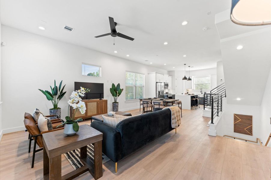 Sleek modern kitchen featuring stainless steel appliances, a spacious island with pendant lighting, and stylish cabinetry.