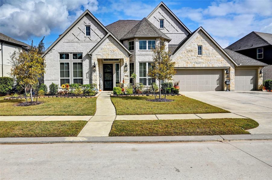 Front exterior of a new home in Artavia 70′, Conroe, TX, highlighting curb appeal (Image 2).
