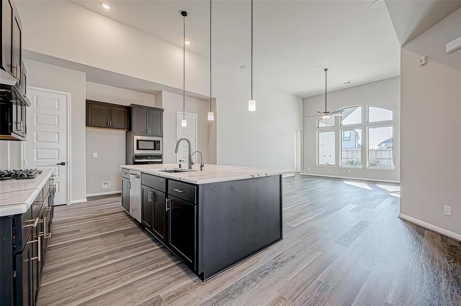 The open-concept layout seamlessly connects the formal dining room, gourmet kitchen, and family room, creating an inviting space for both entertaining and everyday living.