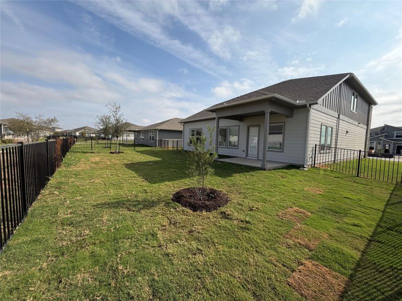 Fenced backyard with a patio and a residential view
