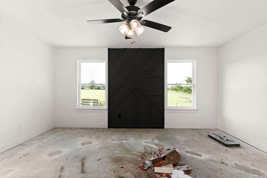 Empty room with ceiling fan and baseboards Empty room with ceiling fan and baseboards