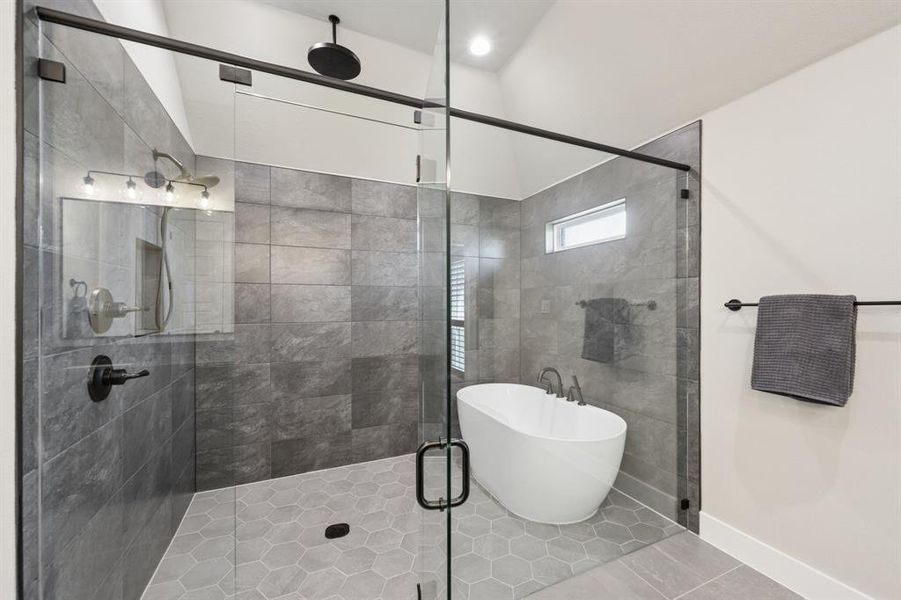 Bathroom featuring tile patterned flooring, a stall shower, and a freestanding tub