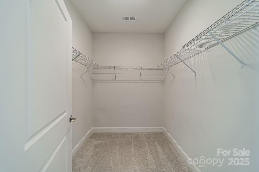 Primary bedroom walk-in closet