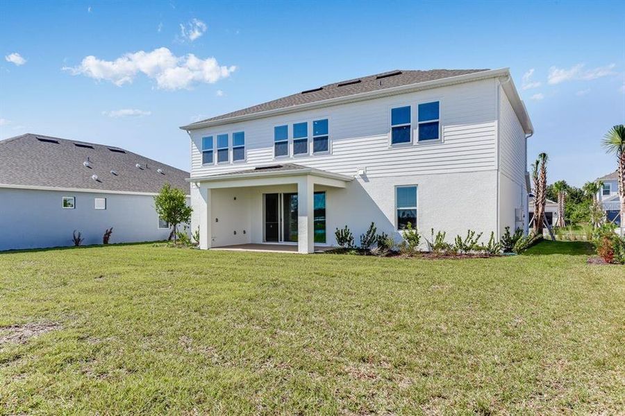Exterior details and patio area of a home in Ardisia Park, New Smyrna Beach (Image 26).