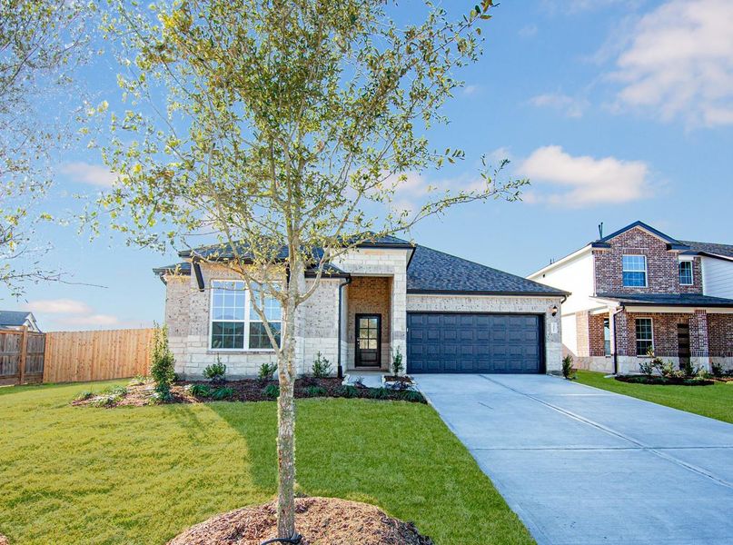Front exterior of a new home in Bluestem, Brookshire, TX, highlighting curb appeal (Image 1). Front exterior of a new home in Bluestem, Brookshire, TX, highlighting curb appeal (Image 1).