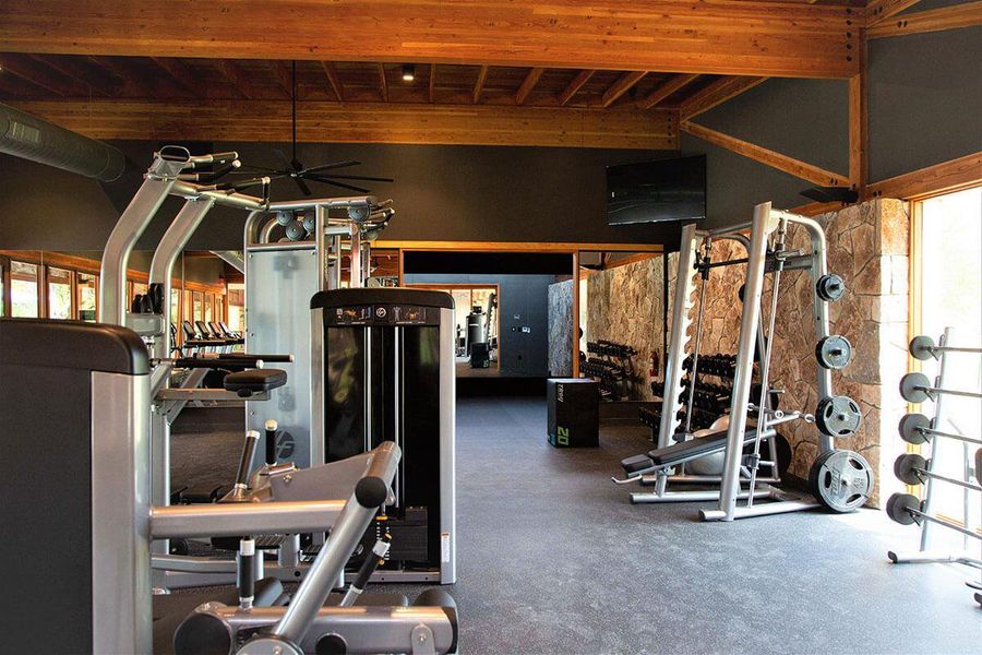 Workout area featuring beamed ceiling