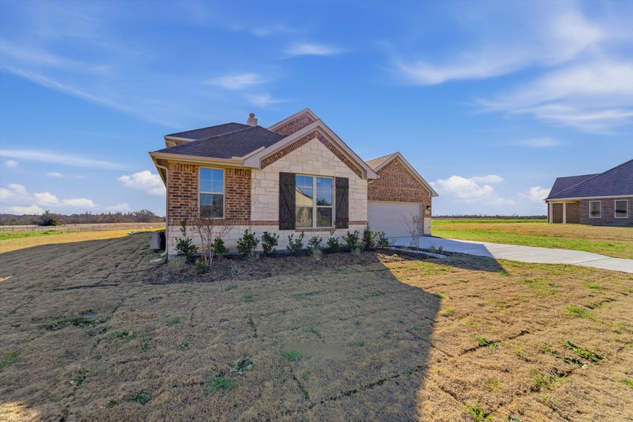 Front exterior of a new home in Fannin Ranch, Leonard, TX, highlighting curb appeal (Image 18).