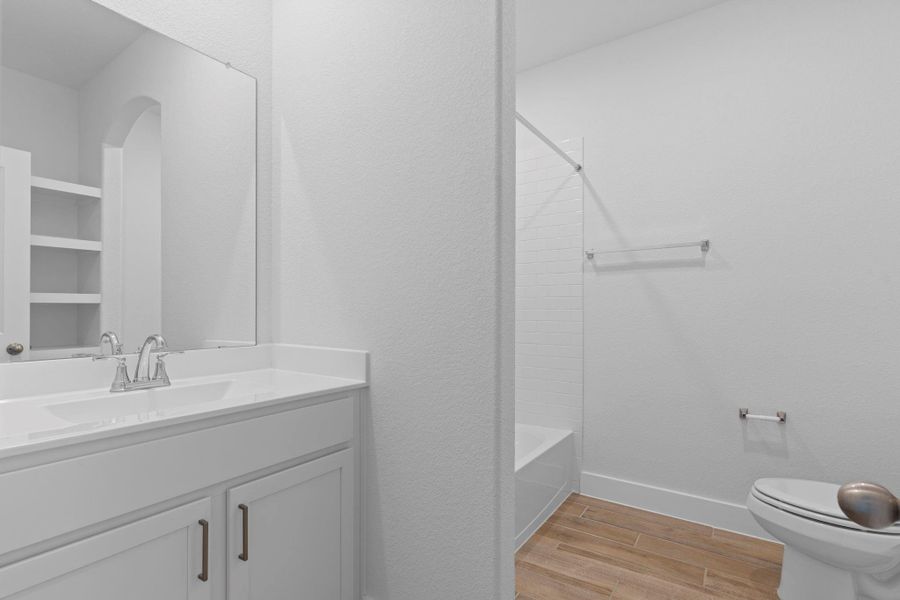 Large guest bathroom with large vanity beautiful shaker cabinets with gorgeous hardware, tub and shower combination.
