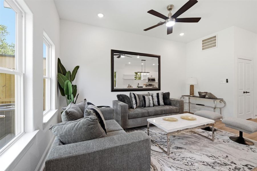 Open concept kitchen, dining and living room, with lots of natural light.