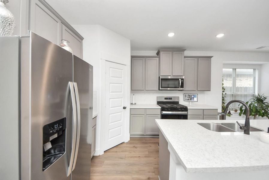 Bright, modern kitchen with a spacious island and stainless steel appliances.