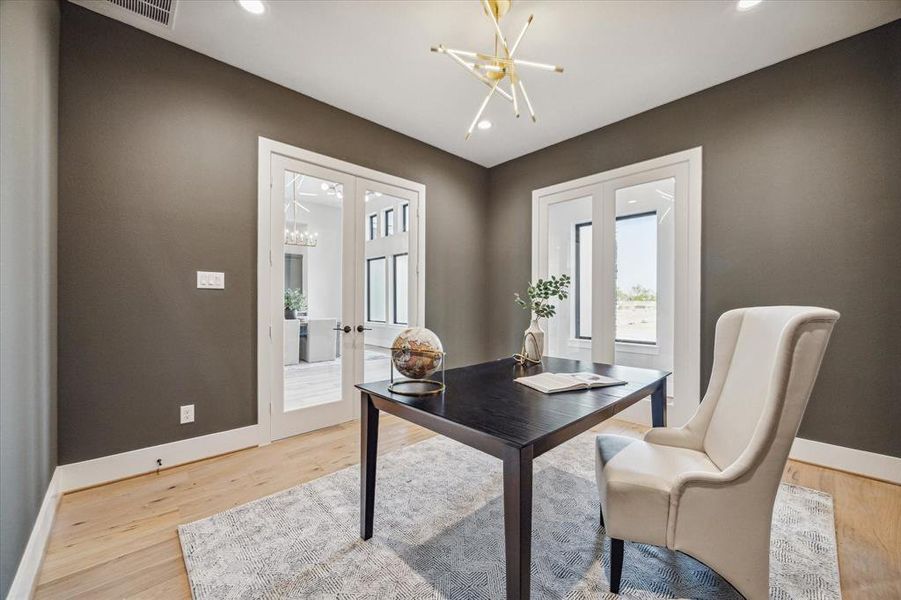 The study has fixed doors on one wall that face a hall that leads to the guest bedroom.