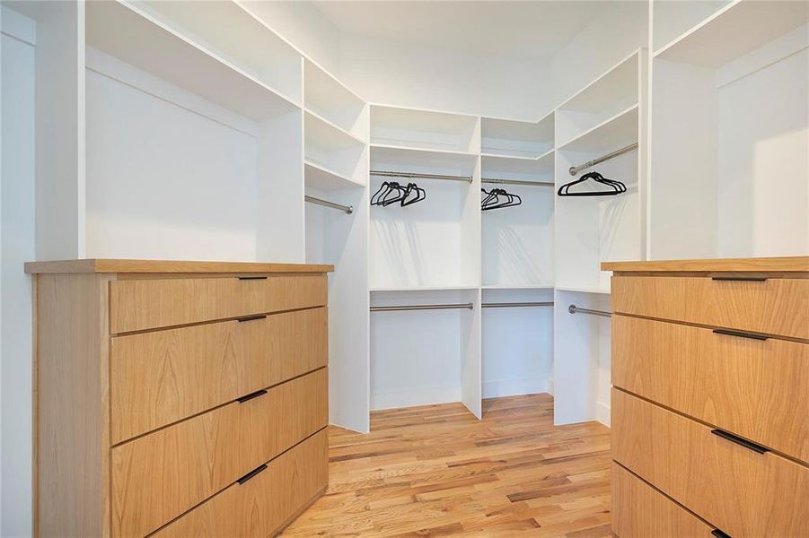 Spacious closet featuring light hardwood / wood-style floors