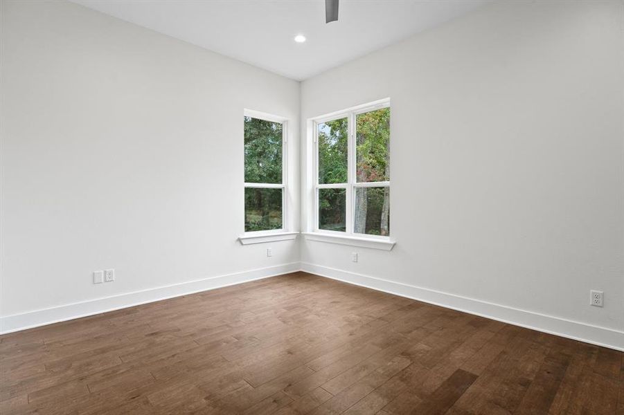 Spare room featuring dark hardwood / wood-style floors Spare room featuring dark hardwood / wood-style floors