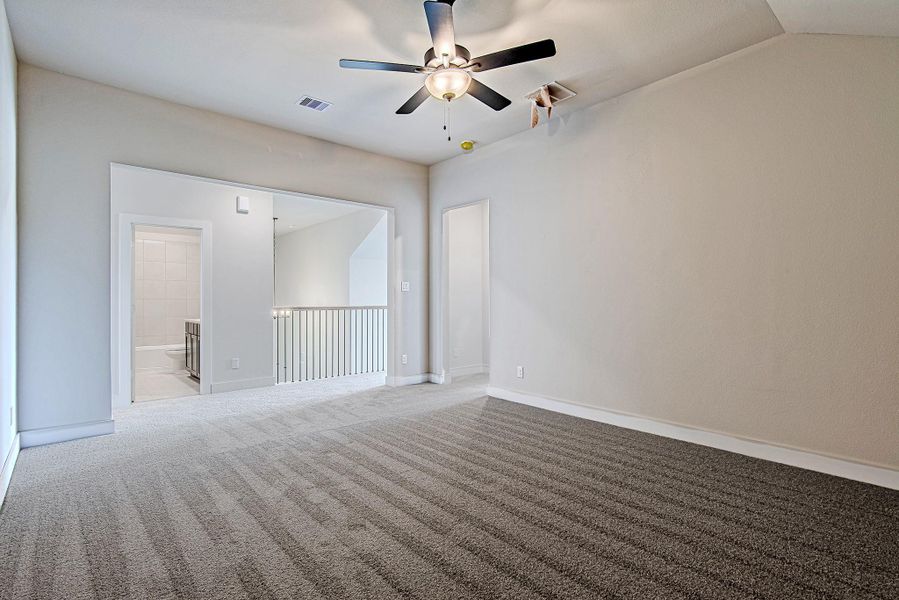 Spacious upstairs bonus area ideal for lounging, study, or play—with views overlooking the stair railing and easy access to the full bathroom.