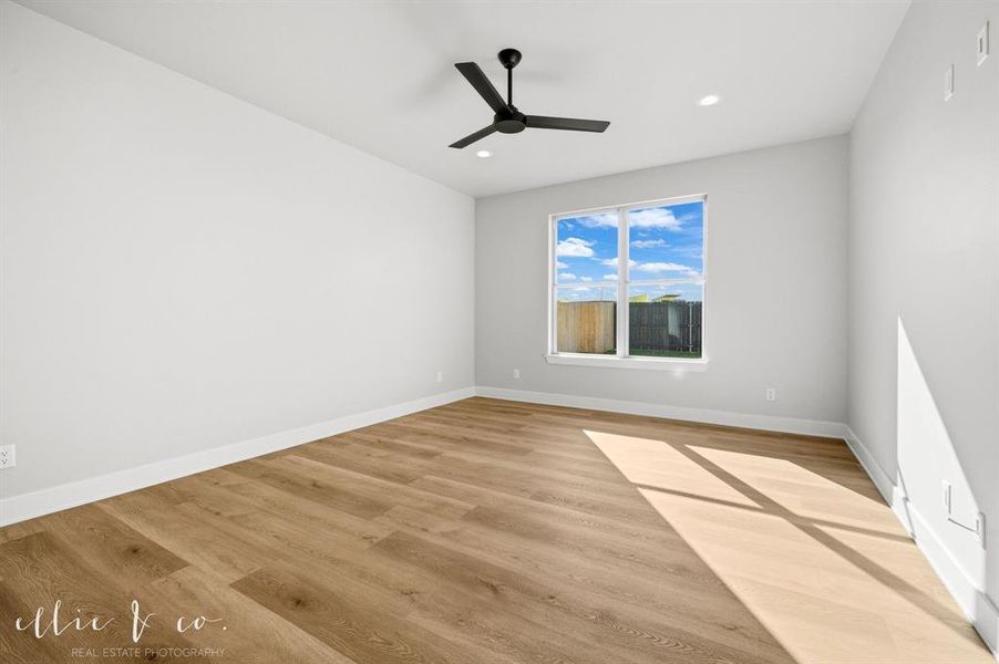 Unfurnished room featuring light wood-style flooring, a ceiling fan, and recessed lighting