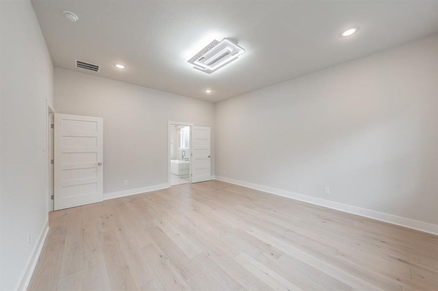 Spare room featuring light wood-style floors and recessed lighting