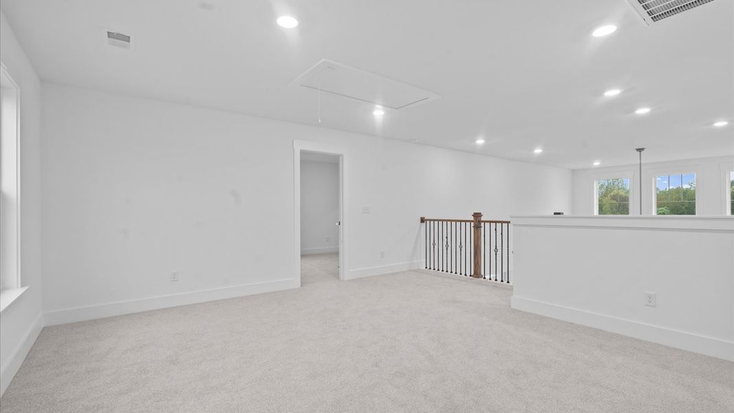 Elegant, carpeted loft that adds a superior layer of flexibility to the home’s design