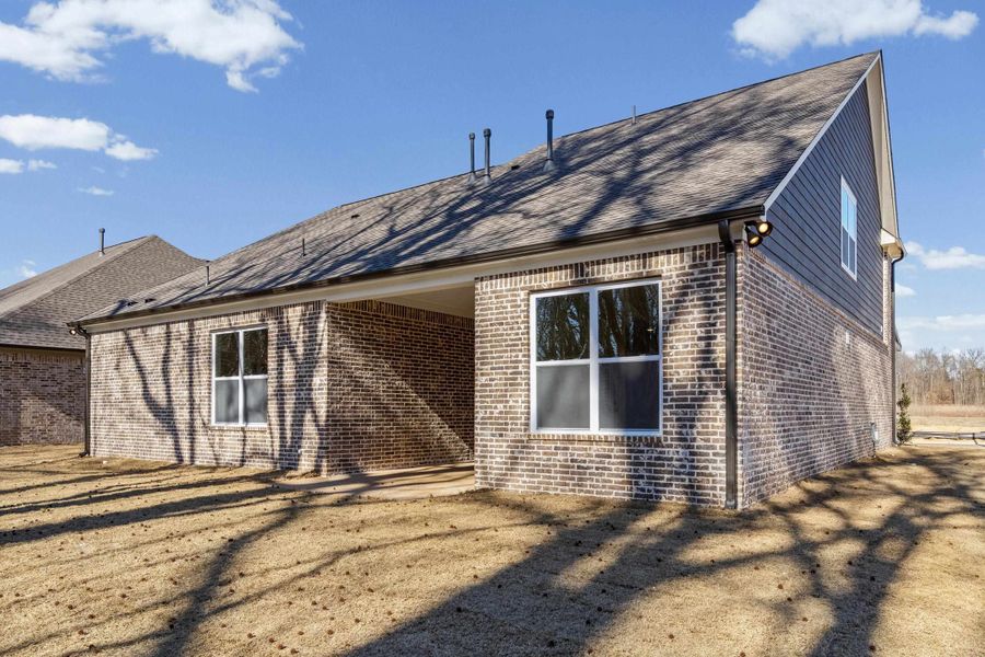 Back of property with brick siding, a patio, and roof with shingles Back of property with brick siding, a patio, and roof with shingles