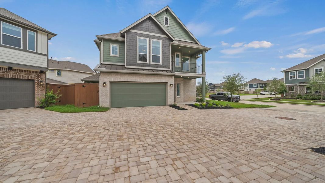 Front exterior of a new home in Elyson Courtyard Collection, Katy, TX, highlighting curb appeal (Image 2). Front exterior of a new home in Elyson Courtyard Collection, Katy, TX, highlighting curb appeal (Image 2).